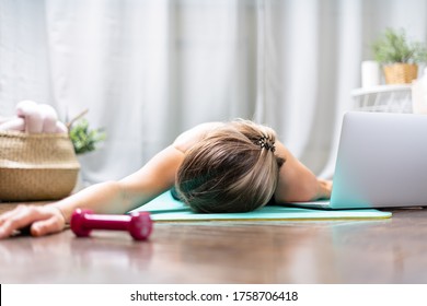 Woman Falling Asleep. Tired After Exercise And Workout. Overtraining Concept. Exhausted Woman Lying On Floor And Resting After Heavy Cardio Training In Home Gym At Yoga Mat.