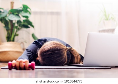 Woman Falling Asleep. Tired After Exercise And Workout. Overtraining Concept. Exhausted Woman Lying On Floor And Resting After Heavy Cardio Training In Home Gym At Yoga Mat.