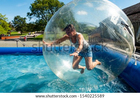 A woman falls in a zorb ball