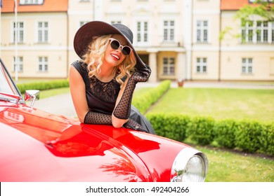 Woman With Fancy Hat And Sunglasses With Retro Car