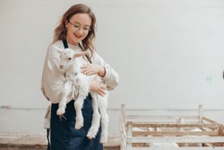 Woman Farmer With Animal Goat On Hand At Eco Farm For Dairy Products.