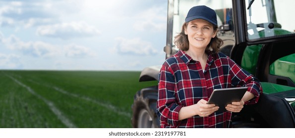 Woman farmer with a digital tablet next to agricultural tractor - Powered by Shutterstock
