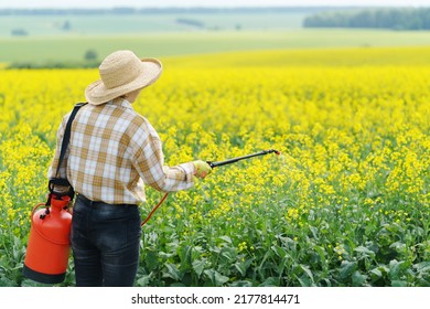 Woman farmer fertilizing rapeseed field with a special liquid. Fertilizing the field. Rapeseed field. - Shutterstock ID 2177814471