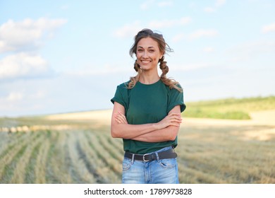 Woman farmer standing farmland smiling Female agronomist specialist farming agribusiness Happy positive caucasian worker agricultural field  - Powered by Shutterstock