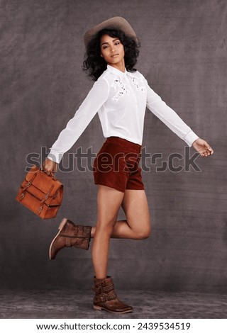 Woman, fashion and country style in studio, trendy clothes and western boots for model. Native American, female person with bag accessory for countryside culture, confident or isolated on background