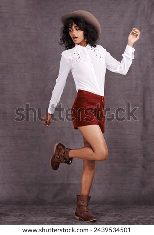 Woman, fashion and cowgirl in studio, country clothing and western boots for surprised model. Native American, female person with trendy hat accessory for countryside culture, isolated on background