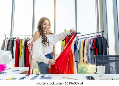 Woman fashion designer smile and using tape for measuring mannequin creating pret-a-porter collection in showroom, concentrated owner of fashion industry business working in atelier on tailoring 
 - Shutterstock ID 1619608954