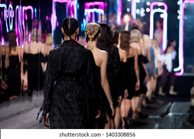 Woman Fashion Models walk back Finale on Runway Ramp during Fashion Week to present New Clothing Collection Spring Summer, on Creative Stage Catwalk with Full Scale Lighting, copy space Image
