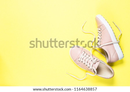 Woman fashion pink shoes on yellow background. Top view copy space.