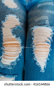 Woman In Fashionable Ripped Jeans