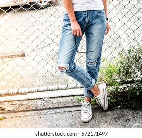 woman in fashionable ripped Jeans