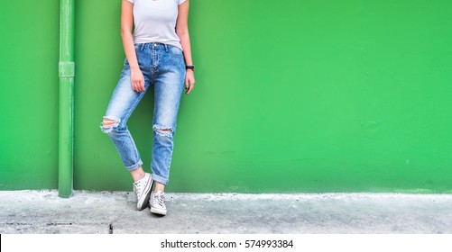 woman in fashionable ripped Jeans