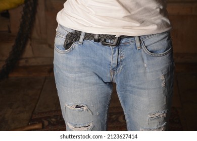 Woman In Fashionable Ripped Jeans .Feet Trendy Girl In Torn Jeans. Hands In Pockets. Teenager And Fashion. Clothes For Young People. Clothing For Teenagers.