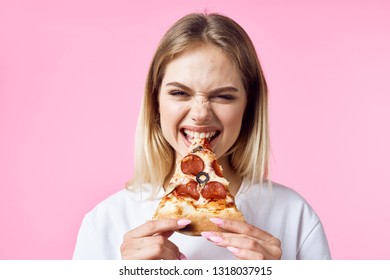 Woman with fast food pizza smile emotion pink background