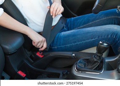 Woman Fastens A Seat Belt. Safe Driving Concept