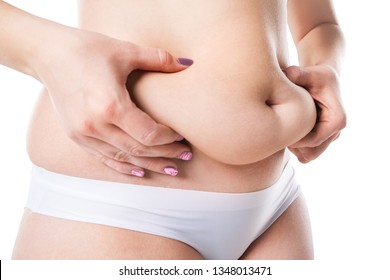 Woman with fat belly, overweight female body isolated on white background, close-up studio shot