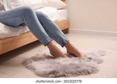 Woman With Faux Fur Rug In Bedroom, Closeup