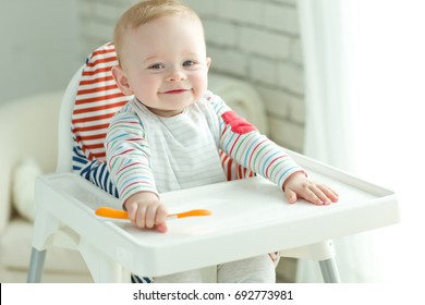 A Woman Is Feeding A Child