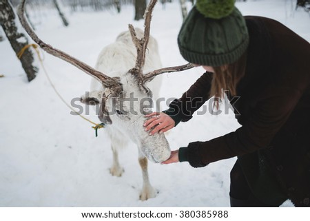 woman feeding deer