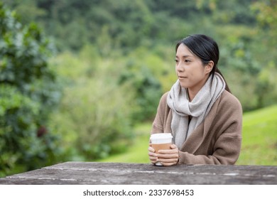 Woman feel so cold and hold with hot coffee - Powered by Shutterstock