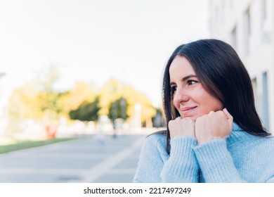 Woman Feeling Cold In Winter Outside Wearing A Blue Sweater