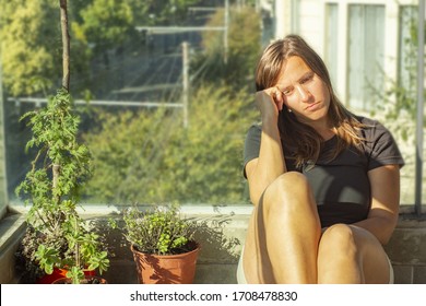 Woman feeling depressed during quarantine at balcony - Shutterstock ID 1708478830