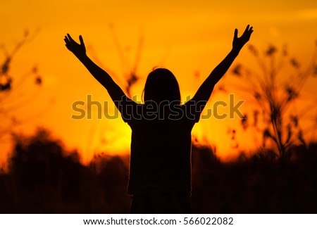 Woman feeling free on sunset and Silhouette of female hands two sides.during beautiful sunset.