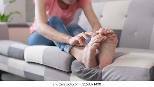 Woman Feeling Itchy On Her Feet