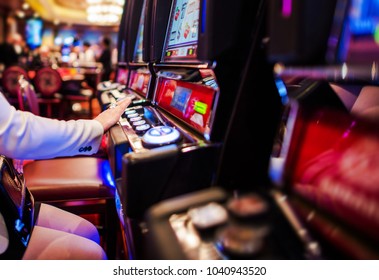 Woman Feeling Lucky Playing Casino Slot Machines. Gambling Theme.