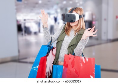 Woman feeling scared when using virtual reality glasses in shopping mall