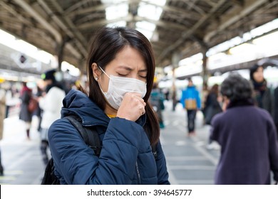 Woman Feeling Sick And Wearing Face Mask In Metro Station Platform