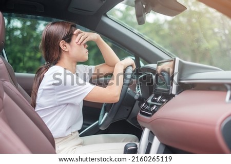 woman feeling stress and angry during drive car long time. Asian girl tired and fatigue having headache stop after driving car in traffic jam. Sleepy, stretching and drunk concept