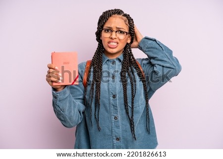 woman feeling stressed, anxious or scared, with hands on head. student calendar or agenda concept