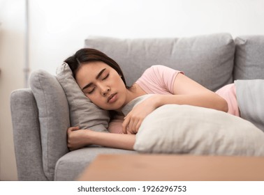 Woman Feeling Unwell. Woman Is Sick Sleep On The Sofa