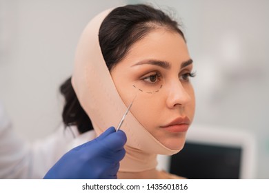 Woman Feeling Worried. Close Up Of Dark-eyed Businesswoman Feeling Worried Before Face Surgery