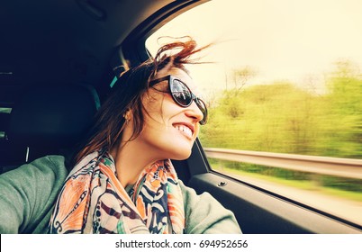 Woman Feels Free And Looks Out From Open Window Car