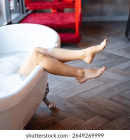 Woman feet in bathrobe at hotel room, closeup