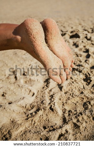 Woman feet closeup of girl relaxing on beach 