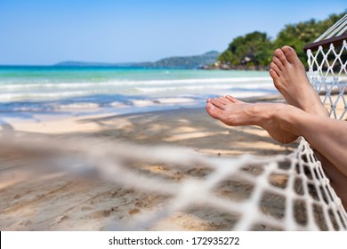 woman feet in hammock on the beach