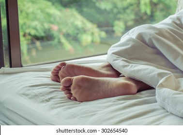 Woman Feet On The Bed