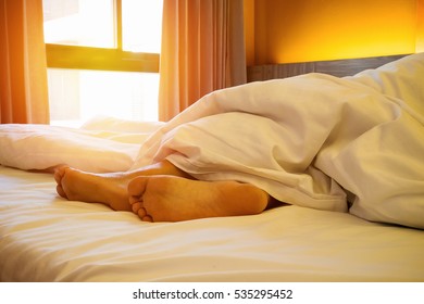 Woman Feet On The Bed