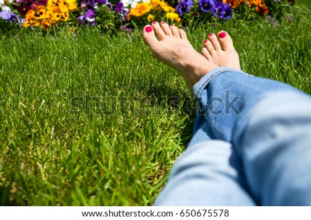 Woman feet on grass barefoot, copy space