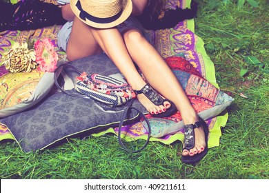 Woman Feet On Grass In Flat Summer Sandals Lean On Pillows  Hat Lay On Legs From Above