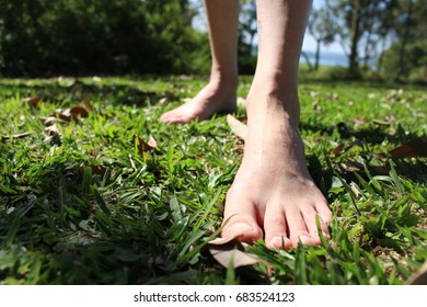 Woman feet on green grass (park) - Shutterstock ID 683524123