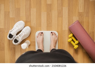 Woman Feet On Scales, First Person View. Fitness, Getting In Shape And Controlling Weight At Home Concept