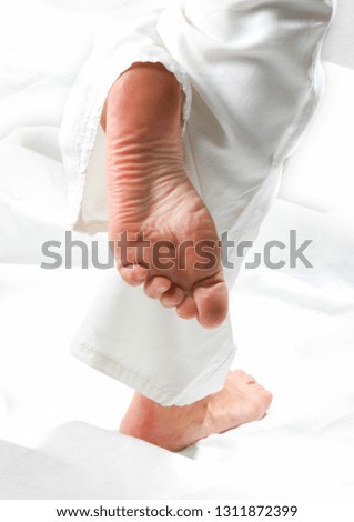 woman feet on white backdrop like saint