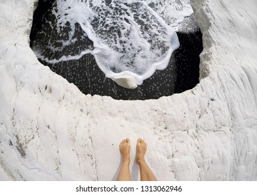 Woman Feet On White Rock On Famous Governor's Beach With Black Sand, Landmark Of Cyprus. POV