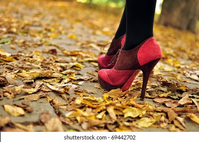 Woman Feet  With Pink Fashion Shoes On A Late Autumn Shooting