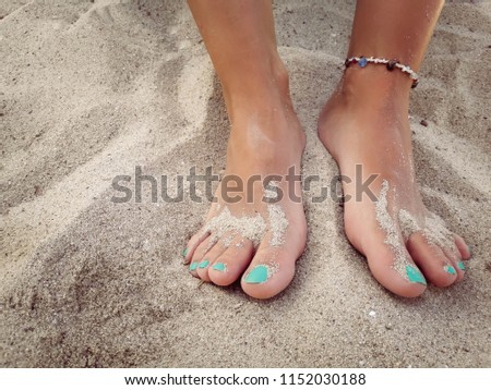 Woman feet in sand /
Copy space. Summer vacation concept
