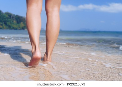 Woman Feet Walk Slow Life And Relax On Sand Tropical Beach With Blue Sky Background. Vacation And Holiday Concept.